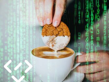 Hand taucht ein Cookie in eine Tasse Kaffee